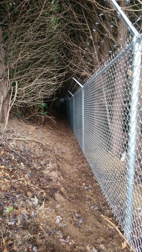 6-foot galvanized chain link fence with barbed wire top on a commercial property in Abbotsford, BC installed by LS Fencing & Metal Work.