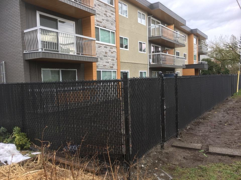Chain link fencing with privacy slats from the LS Fencing project gallery.